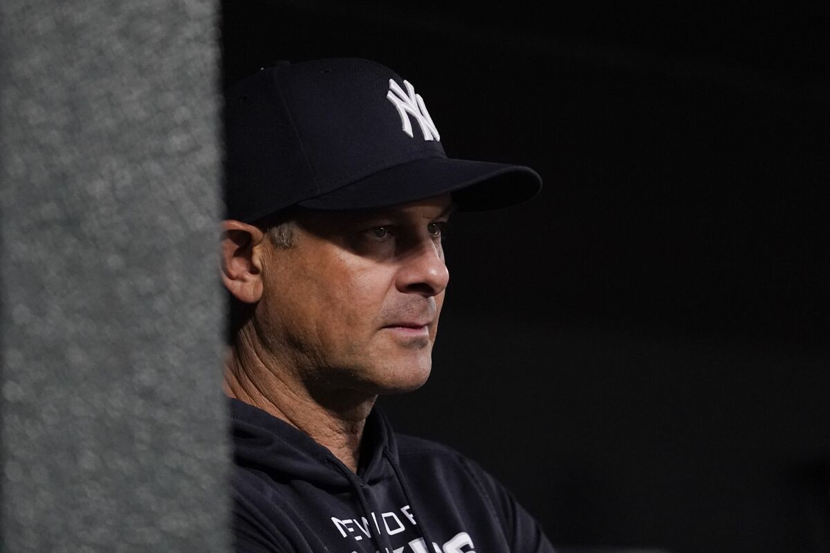 New York Yankees manager Aaron Boone looks on from the dugout during the first inning of a baseball game against the Baltimore Orioles, Saturday, April 16, 2022, in Baltimore. (AP Photo/Julio Cortez)