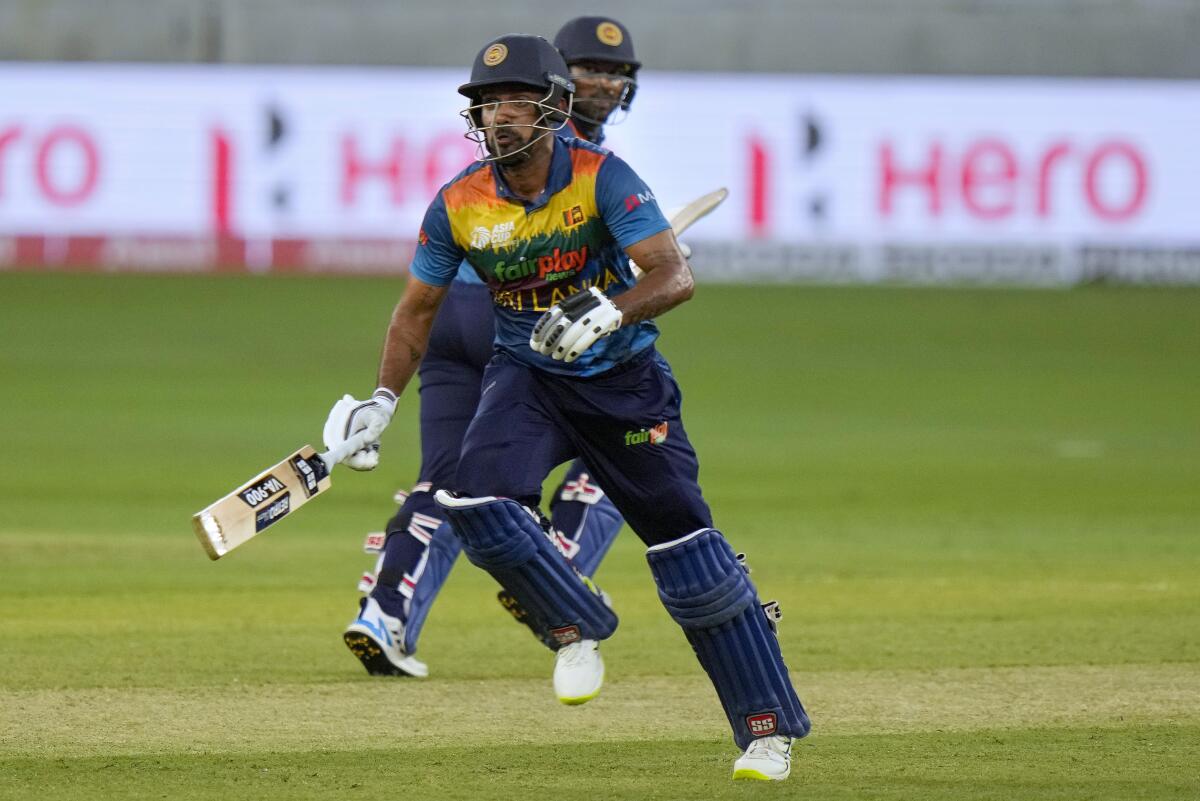Sri Lanka's Danushka Gunathilaka, front, runs between the wickets during the T20 cricket match of Asia Cup between Afghanistan and Sri Lanka, in Dubai, United Arab Emirates, Saturday, Aug. 27, 2022. Gunathilaka has been charged over the sexual assault of a woman after being arrested in his Sydney hotel early Sunday Nov. 6, 2022.(AP Photo/Anjum Naveed,File)