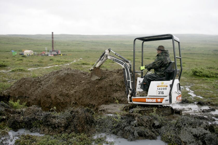 FILE - A worker with the Pebble Mine project digs in the Bristol Bay region of Alaska near the village of Iliamma, Alaska, July 13, 2007. The U.S. Environmental Protection Agency announced a decision Tuesday, Jan. 31, 2023, that would block plans for the proposed Pebble Mine, a copper and gold project in southwest Alaska. (AP Photo/Al Grillo, File)