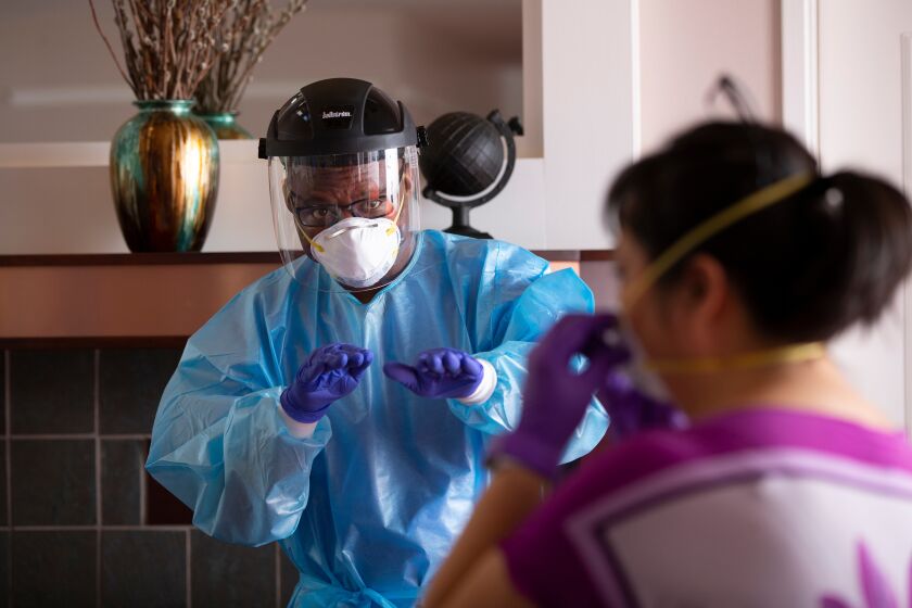 Albert Munanga, regional director of health and wellness at Era Living, leads a personal protective equipment training session at the Ida Culver House Ravenna, a retirement center in Seattle.