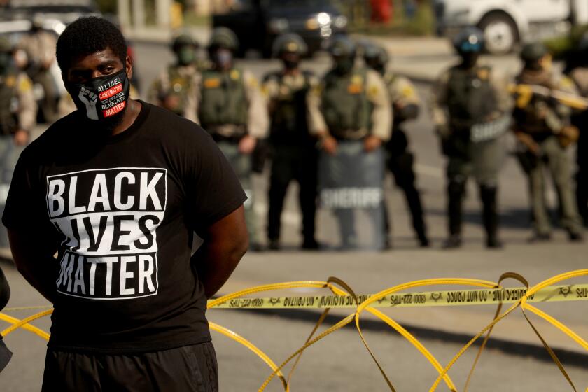 A protester in 2020 after the fatal shootings of Dijon Kizzee, Anthony Guardado and Anthony Weber 