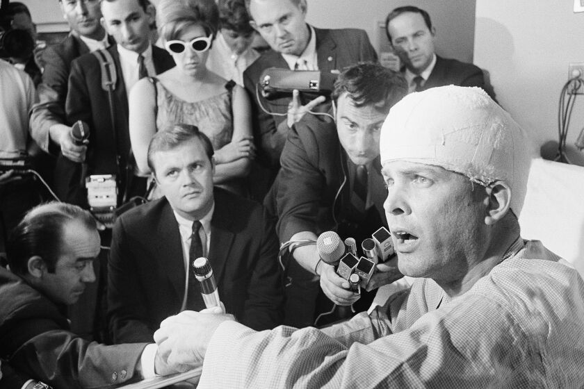 Paul Schrade, 43, hit by one of the bullets fired by Sen. Robert Kennedy's assailant, holds a press conference in his room at Kaiser Hospital in Los Angeles June 10, 1968. Schrade, a Los Angeles representative of the United Auto Workers, sustained a fractured skull but is recovering and is in good Condition. (AP Photo)