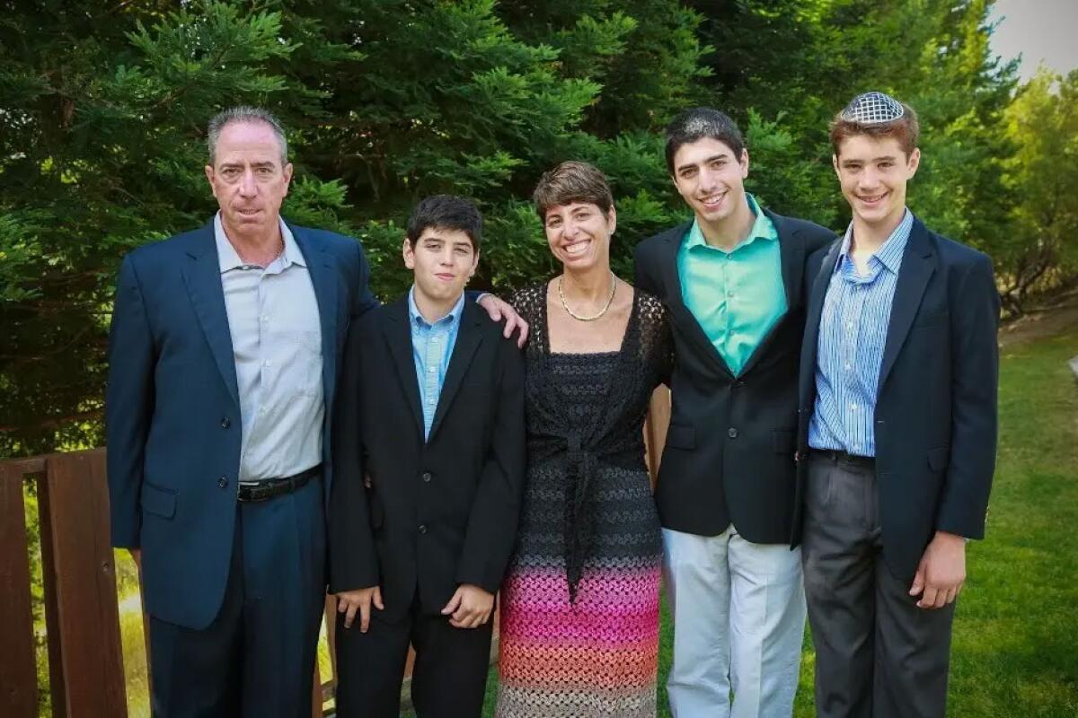 Liron Petrushka, left, and his wife, Naomi, center, pose for a photo with their sons.