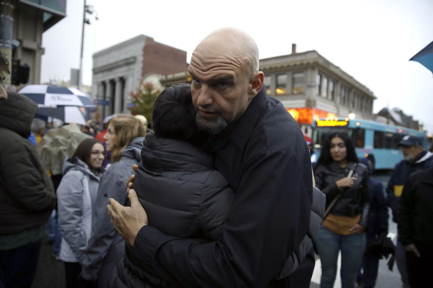 Braddock, Pa., Mayor John Fetterman hugs a person as they gather for a vigil in the aftermath of a deadly shooting at the Tree of Life synagogue in Pittsburgh on Oct. 27, 2018.