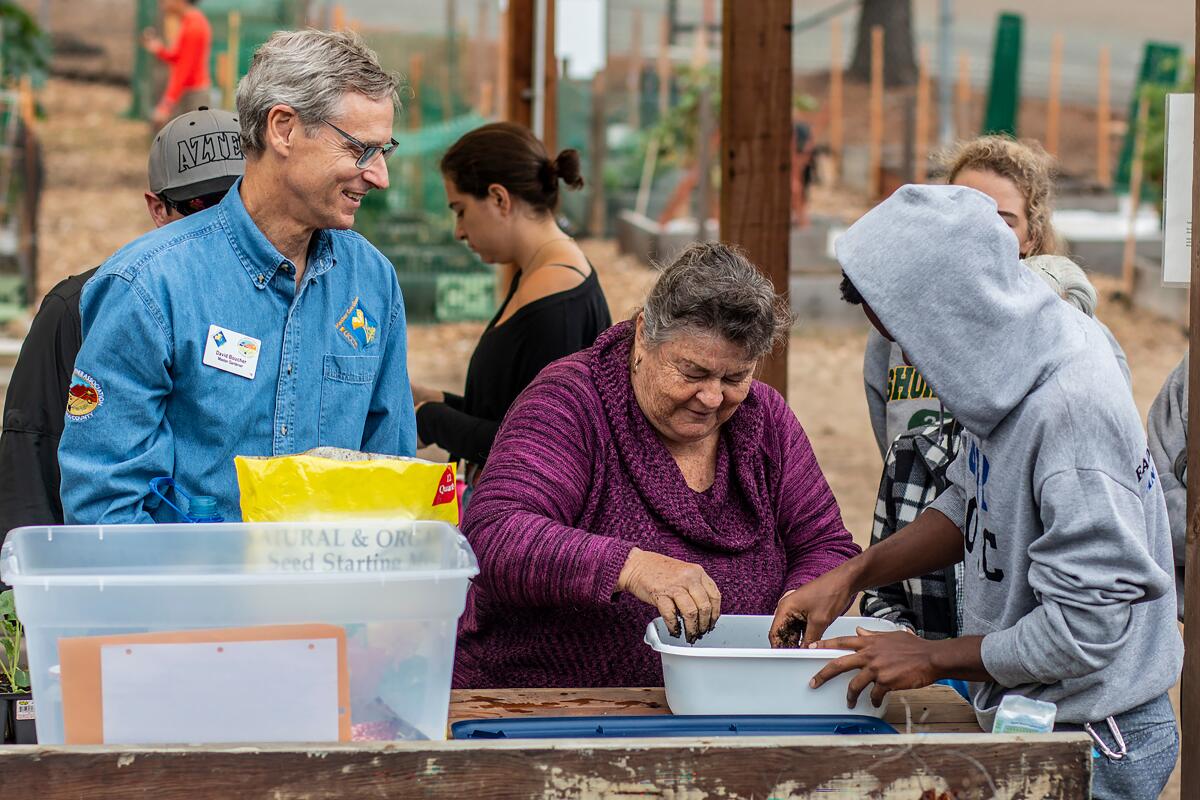 Master Gardener David Boucher, left, teaches past attendees at a workshop.