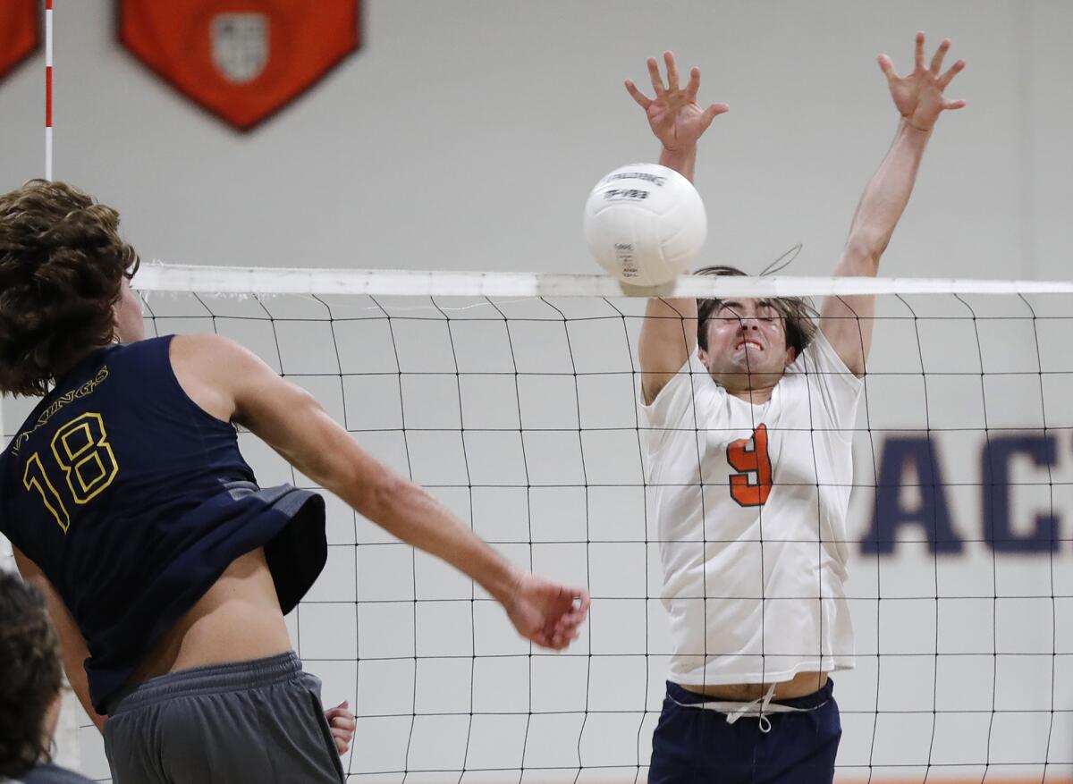 Marina's Aiden Patterson (18) is blocked by Pacifica Christian's Bennett Penticuff (9) during a CIF Division 4 quarterfinal.