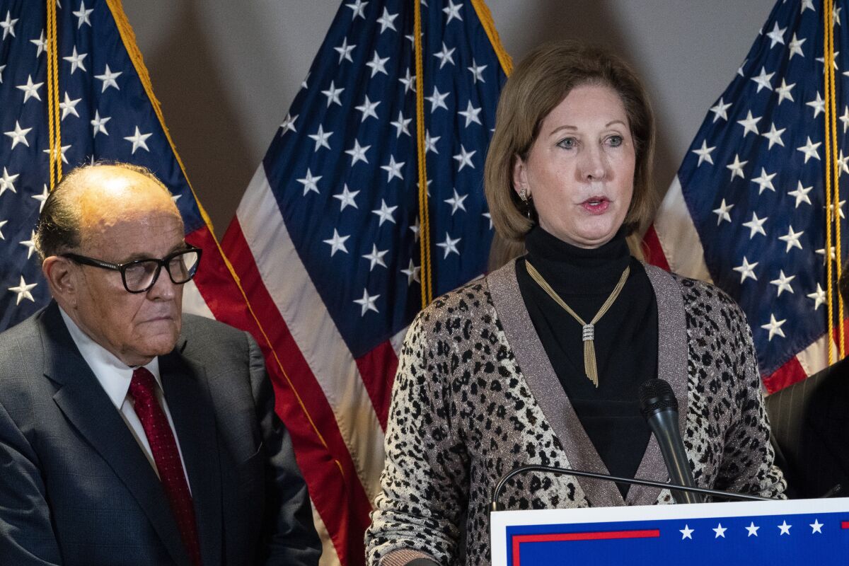 FILE - Sidney Powell, right, speaks next to former Mayor of New York Rudy Giuliani, as members of President Donald Trump's legal team, during a news conference at the Republican National Committee headquarters on Nov. 19, 2020, in Washington. A federal judge cleared the way Wednesday, Aug. 11, 2021, for a defamation case by Dominion Voting Systems to proceed against Trump allies Powell, Rudy Giuliani and Mike Lindell, the founder and CEO of MyPillow, who had all falsely accused the company of rigging the 2020 presidential election. U.S. District Judge Carl Nichols handed down a ruling Wednesday that found there was no blanket protection on political speech. (AP Photo/Jacquelyn Martin, File)