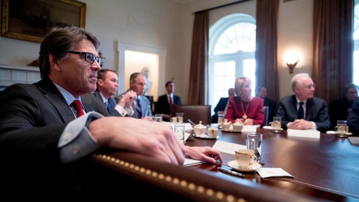 Energy Secretary Rick Perry, left, listens as President Donald Trump speaks during meeting in the Cabinet Room of the White House in Washington on March 13.