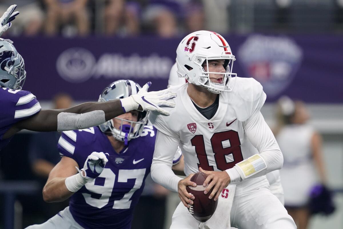 Stanford quarterback Tanner McKee is pressured by Kansas State defensive end Aaron Armitage (97) and others on Saturday.