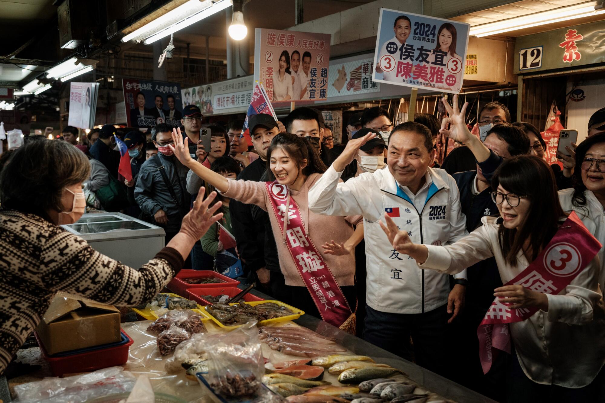 A political candidate and supporters in a crowded market