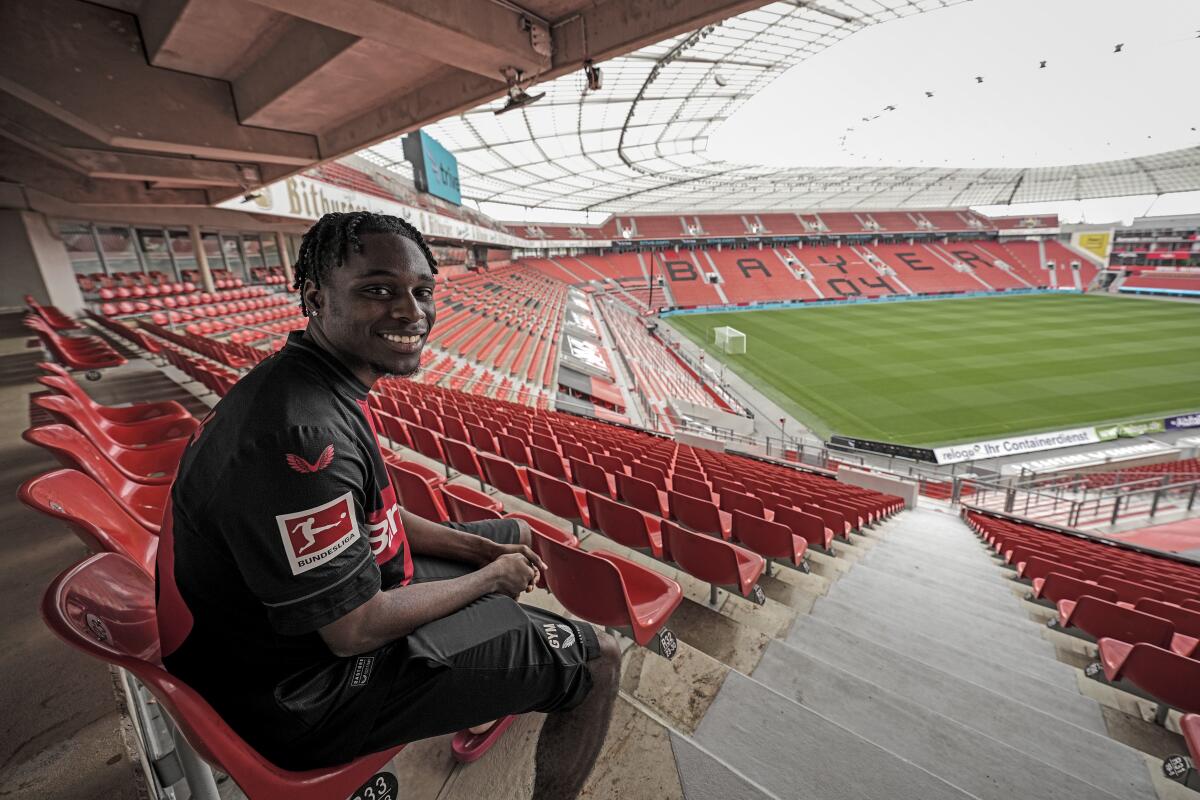 Dutch soccer player Jeremie Frimpong of Bundesliga club Bayer Leverkusen sits on the tribune after an interview with The Associated Press at the BayArena in Leverkusen, Germany, Tuesday, Aug. 29, 2023. Much will depend on Jeremie Frimpong if Bayer Leverkusen can take the next step to challenge for the German title. Frimpong is a key part of the eye-catching style coach Xabi Alonso favors at Leverkusen.(AP Photo/Martin Meissner)