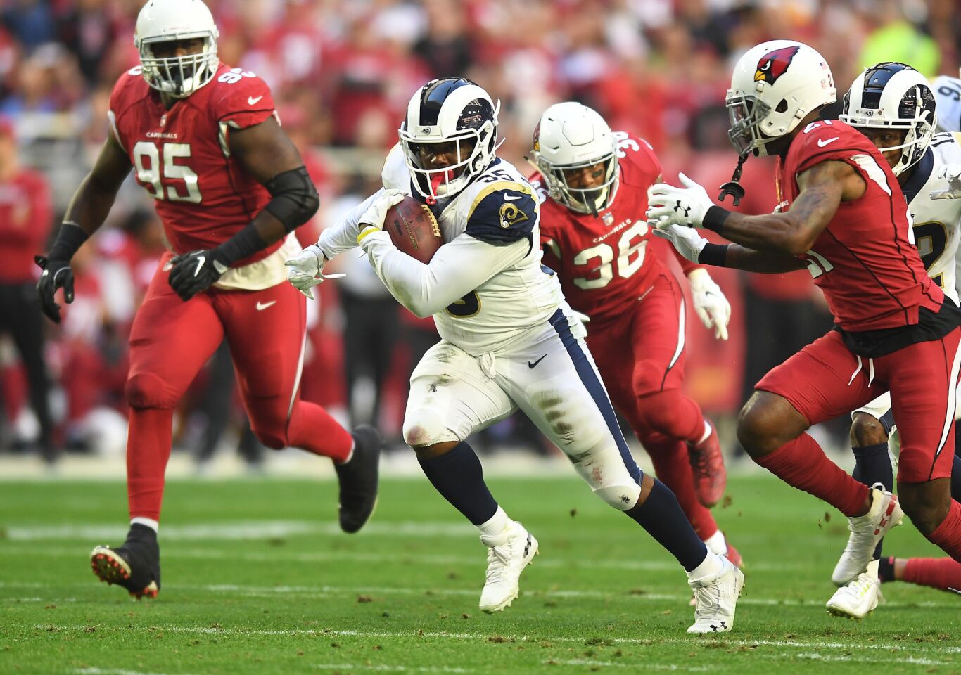 Rams running back C.J. Anderson picks up big yards against the Arizona Cardinals in the second quarter at State Farm Stadium on Sunday.