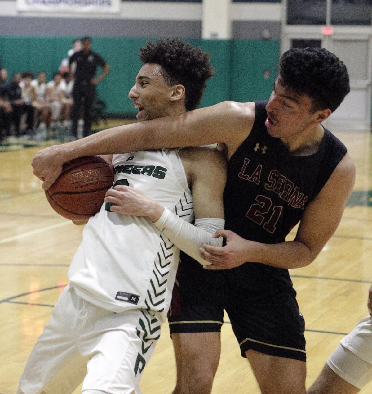Providence's Jordan Shelley fights to take a rebound out of the arms of La Serna's Jacob Leija during Tuesday's CIF Southern Section Division III-AA quarterfinal game.
