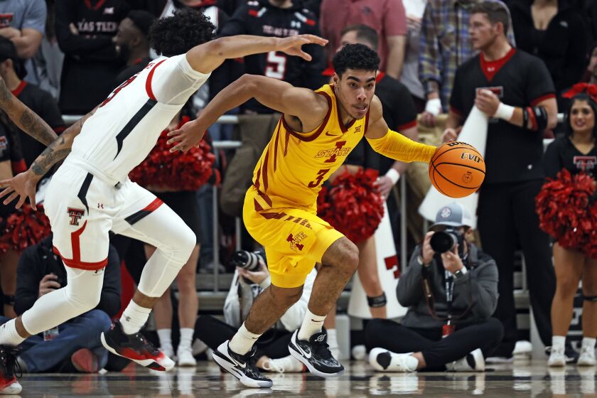 Iowa State's Tamin Lipsey, right, dribbles around Texas Tech's D'Maurian Williams, left, during the first half of an NCAA college basketball game Monday, Jan. 30, 2023, in Lubbock, Texas. (AP Photo/Brad Tollefson)