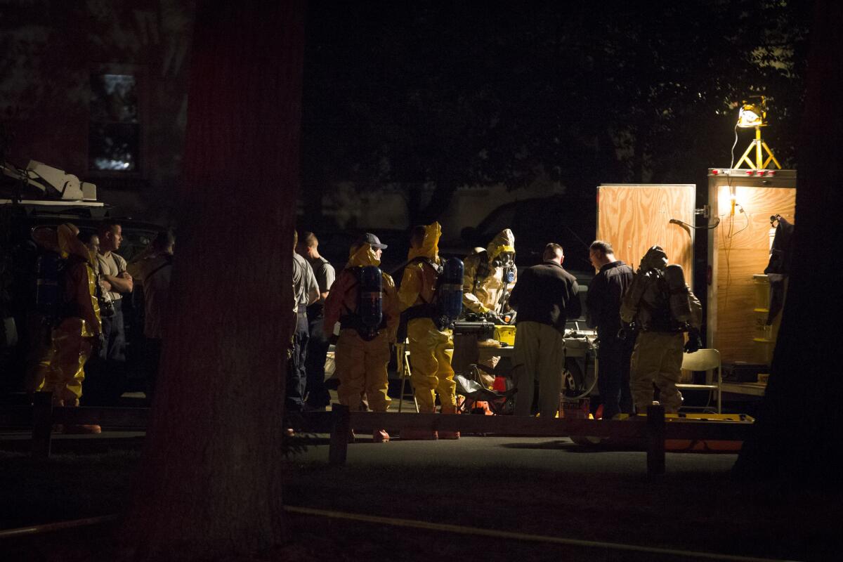 Hazardous materials personnel prepare to enter the apartment complex where Miriam Carey lived in Stamford, Conn.