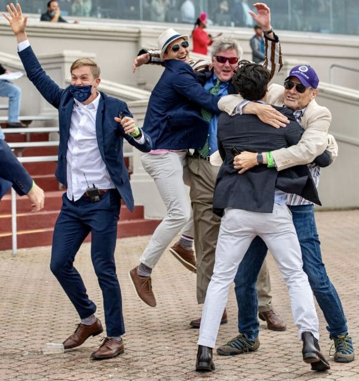 Del Mar's Bill Strauss, far right, and co-owners of Hot Rod Charlie celebrate winning the $1 million Louisiana Derby.