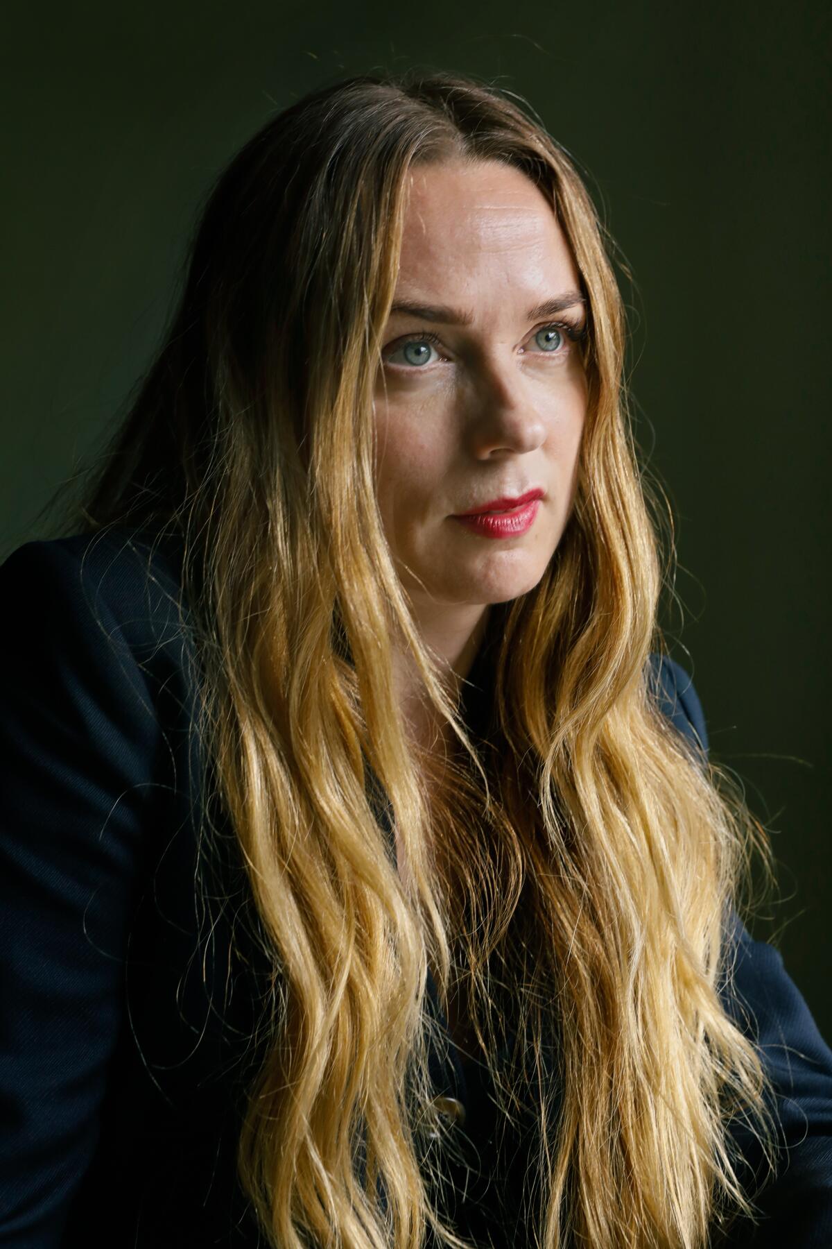 A close-up portrait of Kerry Condon with her long hair draping down her shoulders.