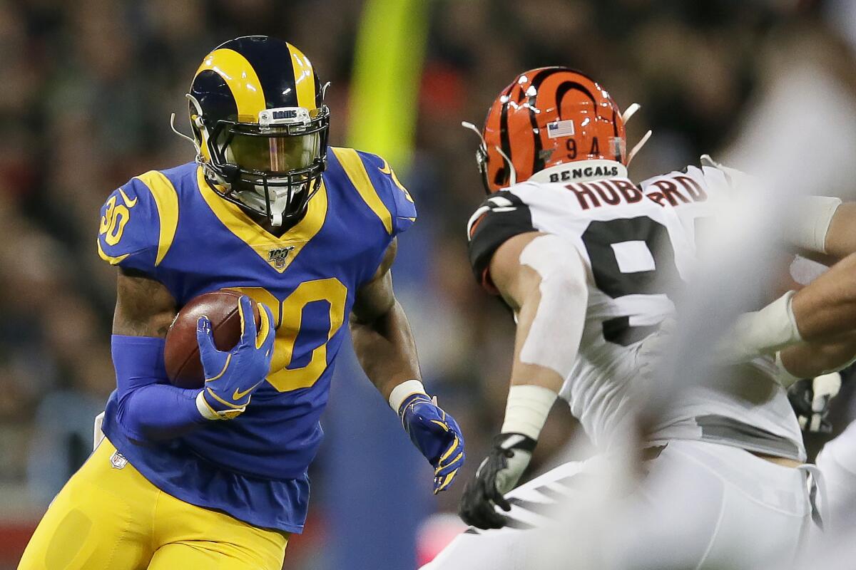 Rams running back Todd Gurley (30) runs against Cincinnati Bengals defensive end Sam Hubbard during the first half on Oct. 27 at Wembley Stadium in London.