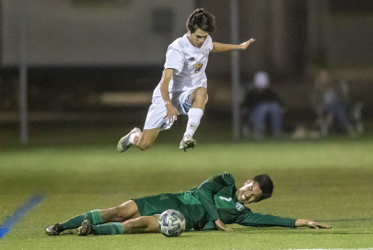 Fountain Valley's Daniel Oakes leaps over Edison's Nathan Peterson during a Surf League boys' soccer match on Wednesday.