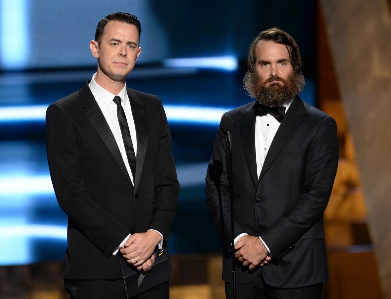 A cleanshaven Colin Hanks and a scruffy Will Forte appear onstage at the Emmys.
