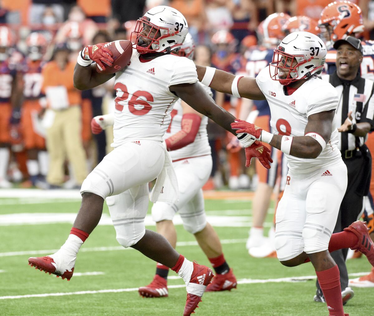 Rutgers defensive lineman CJ Onyechi (26) recovers a fumble in the fourth quarter of an NCAA college football game against Syracuse, Saturday, Sept. 11, 2021, at the Carrier Dome in Syracuse, N.Y. (Dennis Nett/The Post-Standard via AP)