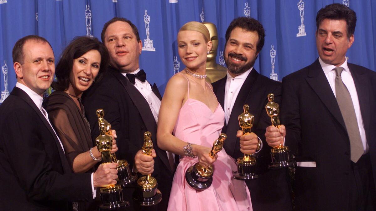 From left to right, David Parfitt, Donna Gigliotti, Harvey Weinstein, Gwyneth Paltrow, Edward Zwick and Marc Norman celebrate after receiving the Oscar for best picture for "Shakespeare In Love" during the Academy Awards on March 21, 1999 in Los Angeles.