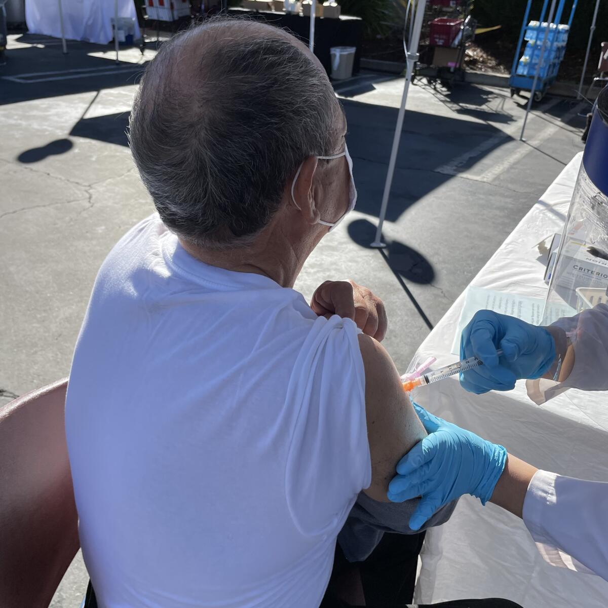 Lorenzo Arellano, 69, gets his first dose of COVID-19 vaccine in Santa Ana.