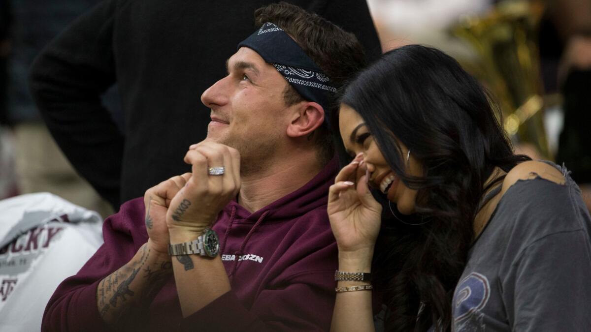 Johnny Manziel sits with his fiance Bre Tiesi during a college basketball game between Kentucky and Texas A&M on Feb. 10.