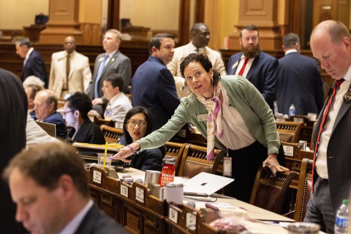 A lawmaker registers her vote in the House chamber