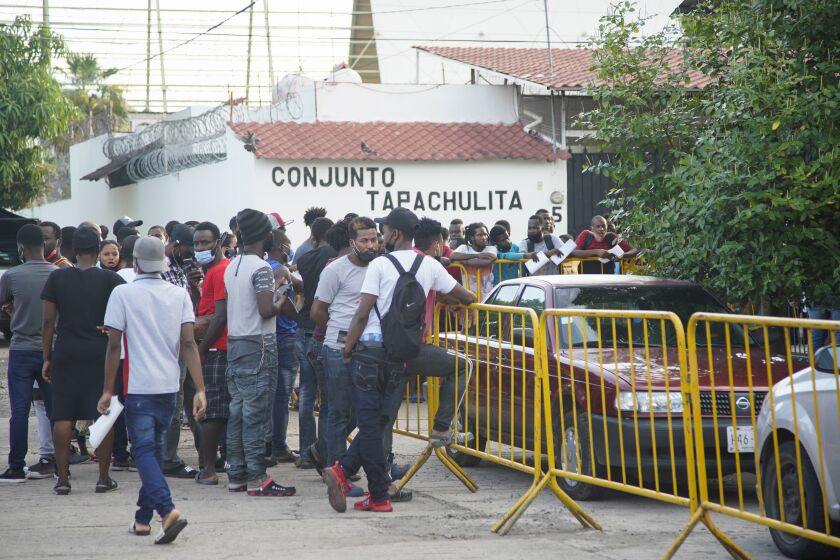Asylum seekers wait outside the office in Tapachula responsible for identifying refugees