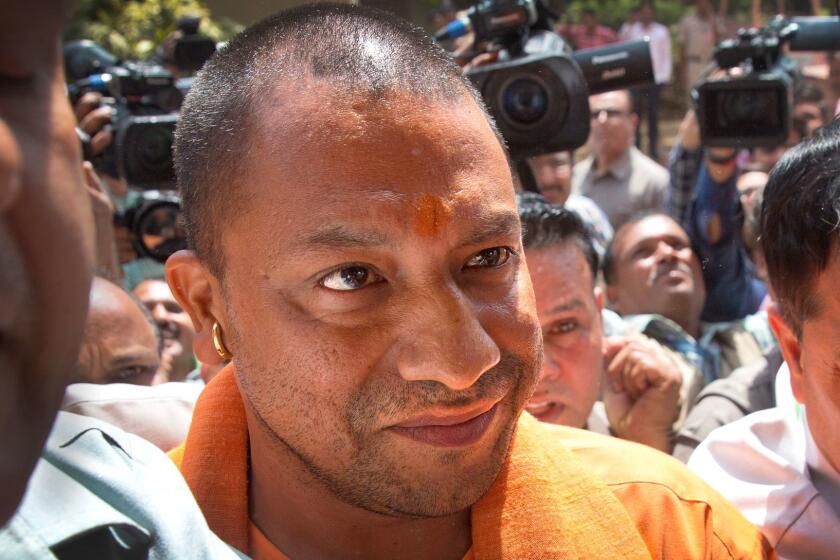 The new Chief Minister of the northern Indian state of Uttar Pradesh Yogi Adityanath arrives at the Parliament in New Delhi, India, Tuesday, March 21, 2017. Adityanath, a hardline Hindu religious leader was sworn in Sunday as the chief minister of India's most populous state. He arrived in the capital on Tuesday to meet Prime Minister Narendra Modi and other party leaders. (AP Photo/Manish Swarup)