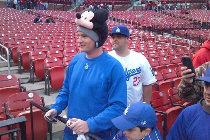Dodgers fan Gabe Prewitt of Lexington, Ky., shows off his Mickey Mouse hat while watching batting practice before Game 6 of the National League Championship Series between the Dodgers and St. Louis Cardinals at Busch Stadium on Friday.