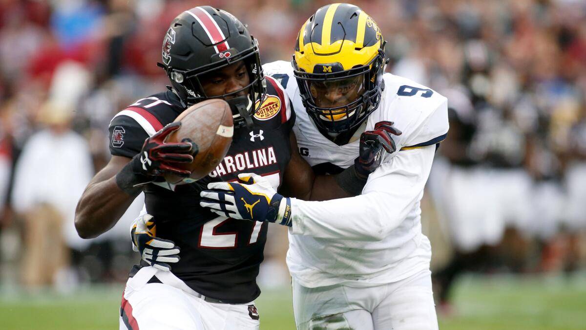 South Carolina running back Ty'Son Williams is stopped by Michigan linebacker Mike McCray after picking up some yardage during the second quarter on Monday.