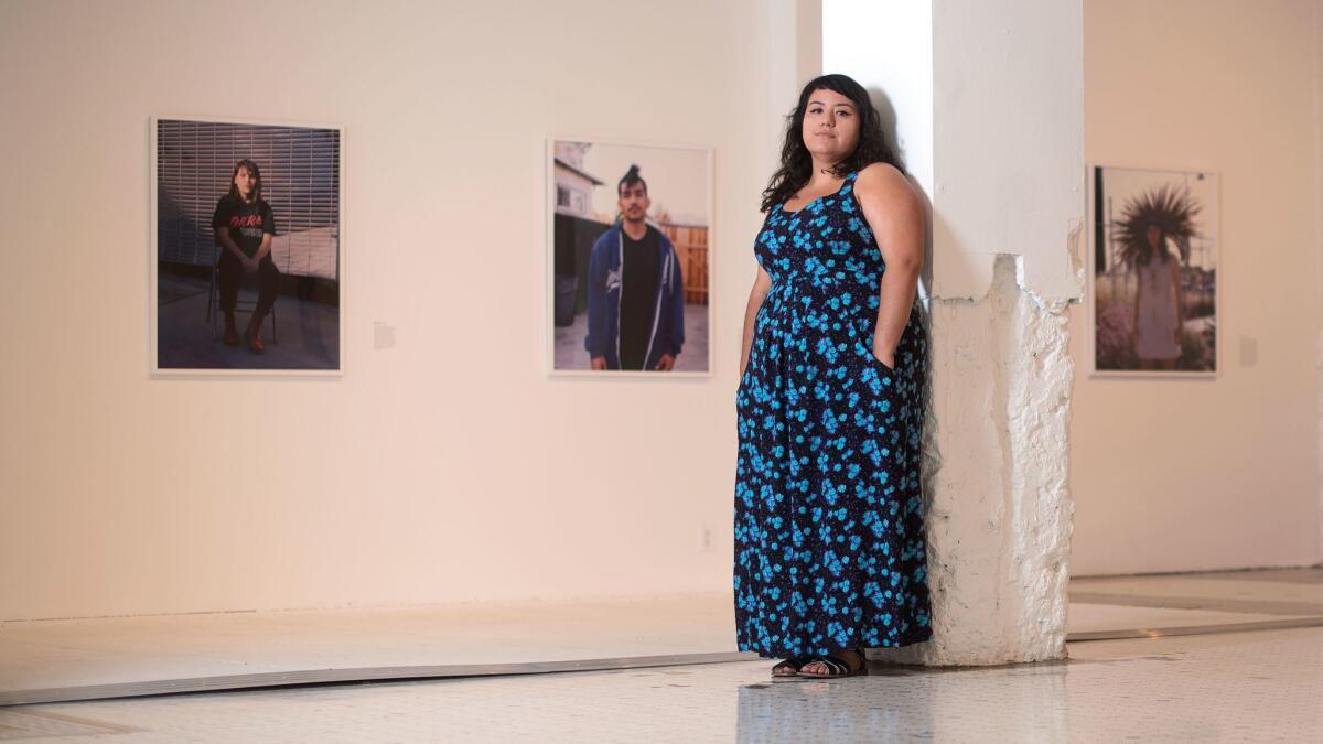 Photographer Star Montana stands amid her portraits of L.A. denizens, now on view at the Main Museum in downtown Los Angeles.