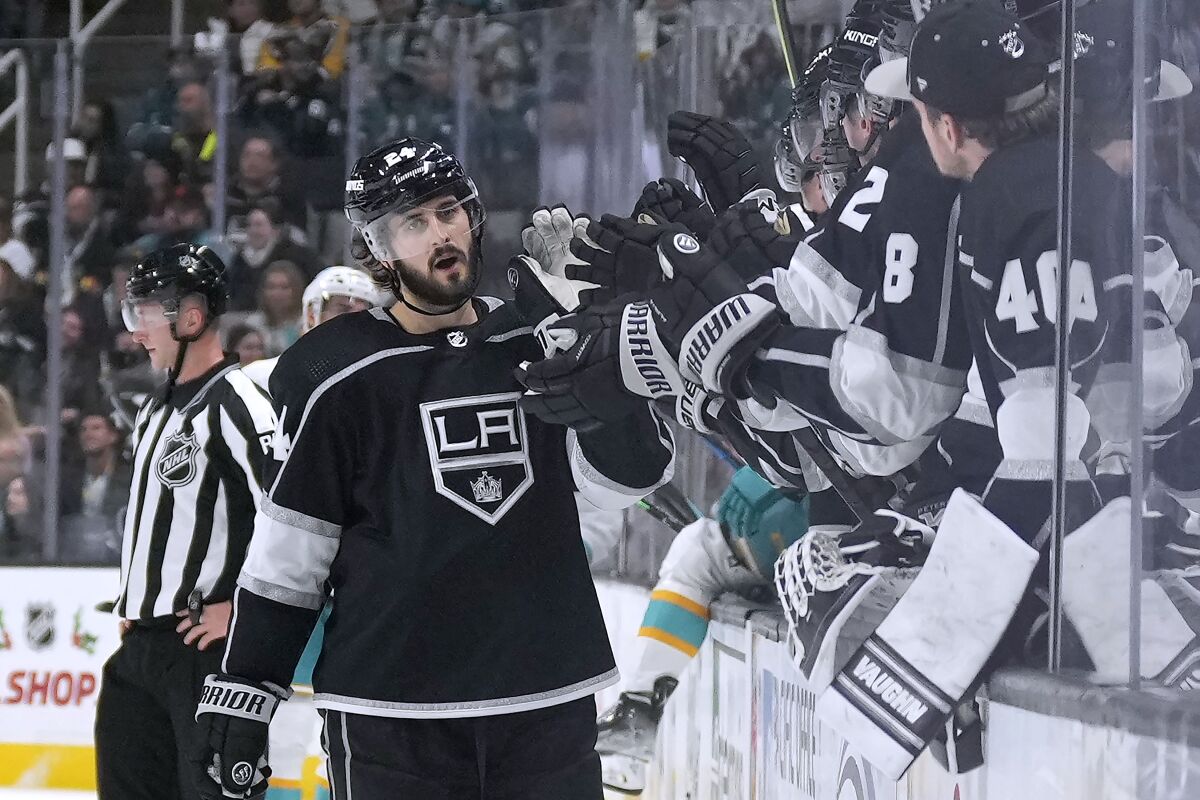 Los Angeles Kings center Phillip Danault (24) is congratulated by teammates after scoring against the San Jose Sharks during the first period of an NHL hockey game Friday, Nov. 25, 2022, in San Jose, Calif. (AP Photo/Tony Avelar)