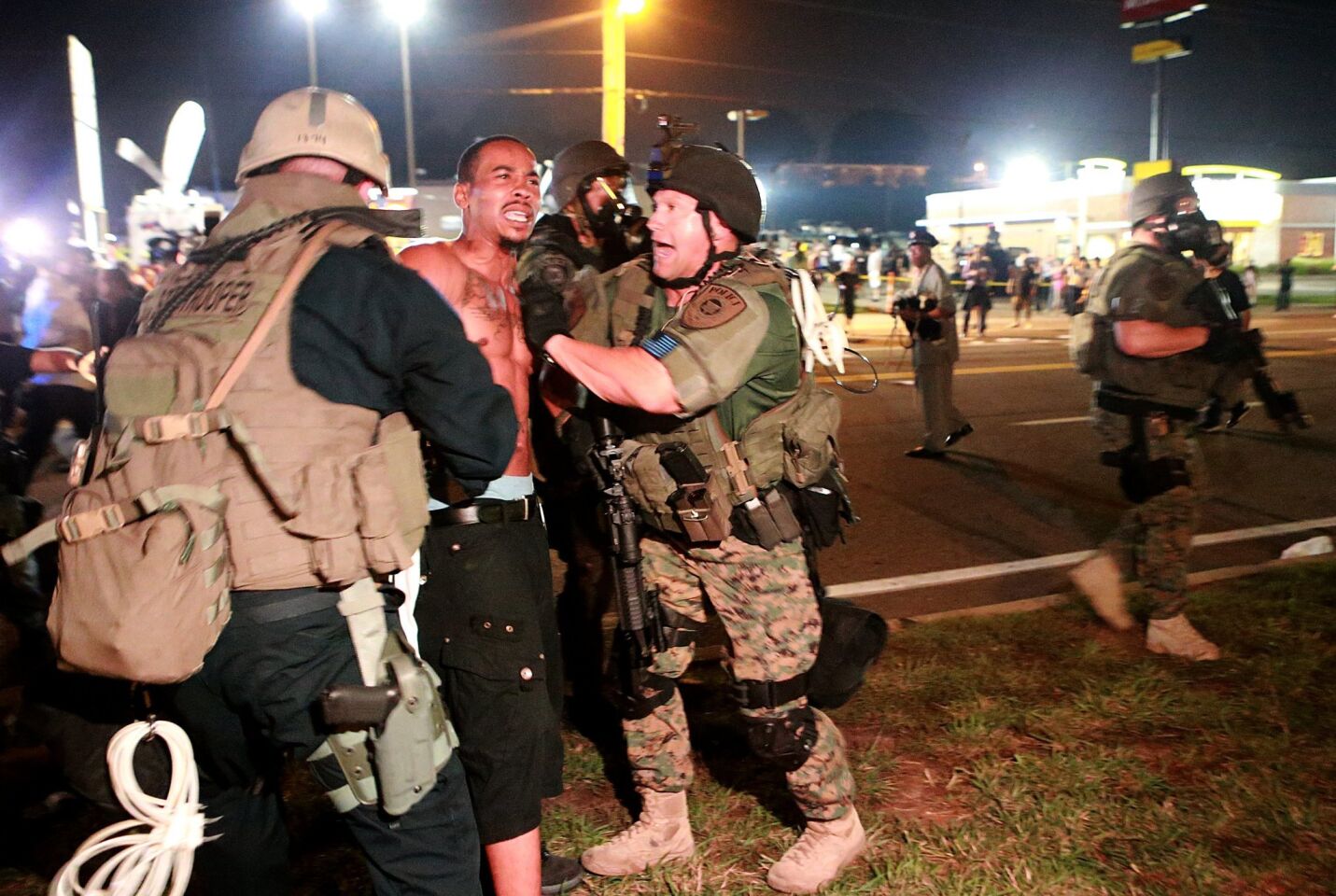 A protestor is detained in Ferguson.