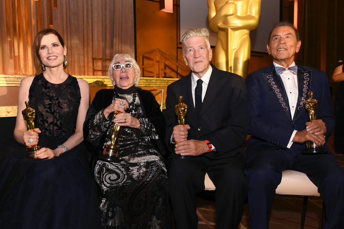 Geena Davis, Lina Wertmüller, David Lynch, and Wes Studi show off their Oscars at the Governors Awards. 