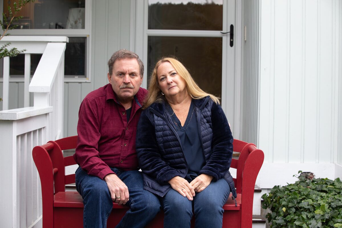 Jim Owen and Carolynn Comstock, singers in the Skagit Valley Chorale, sit outside their home in Anacortes, Wash.