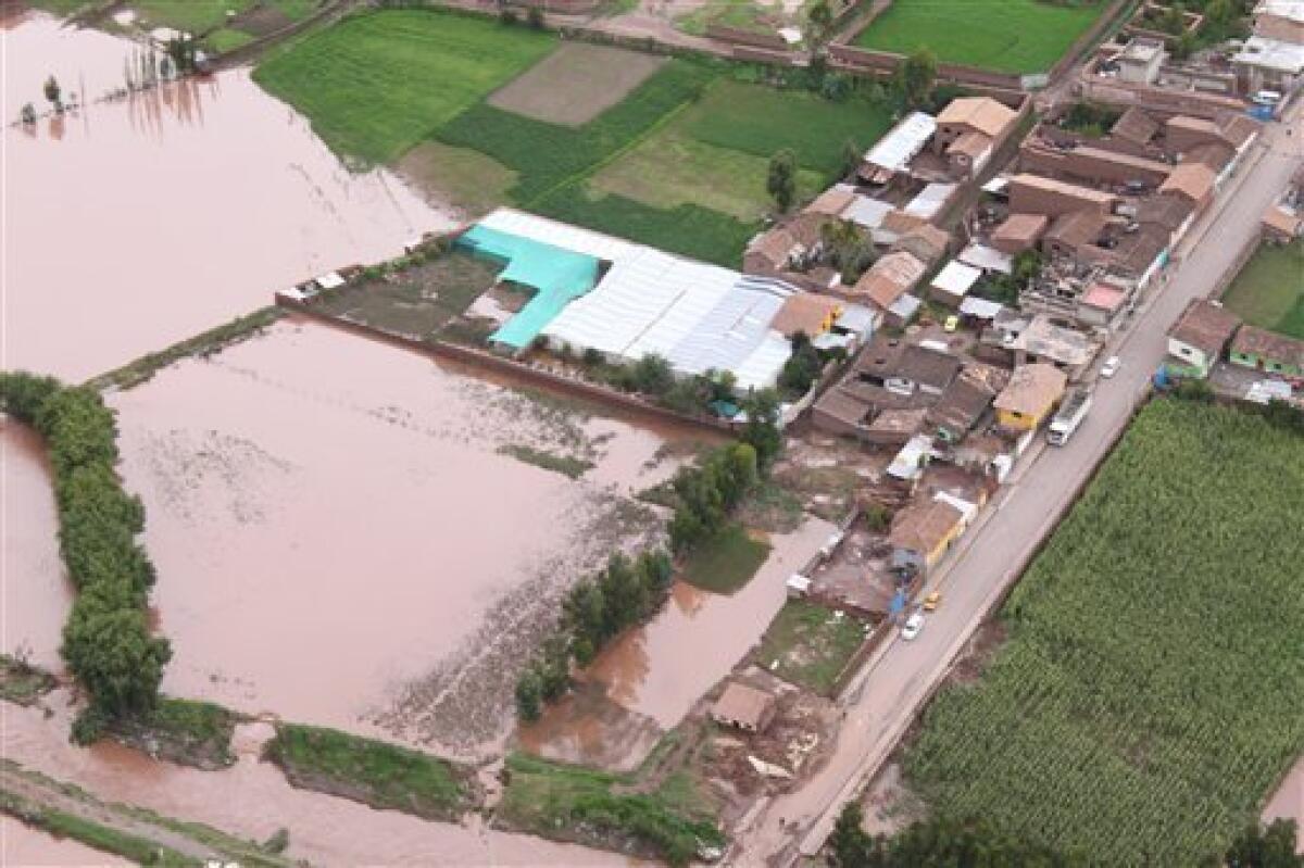 In this photo released by the Peruvian Government Press office a flooded area is seen in this aerial view due to the overflow of the Urubamba river in Cuzco, Peru, Tuesday, Jan. 26, 2010. Heavy rains and mudslides in Peru blocked the train route to the ancient Inca citadel of Machu Picchu, keeping nearly 2,000 tourists stranded.(AP Photo/Government Press office))