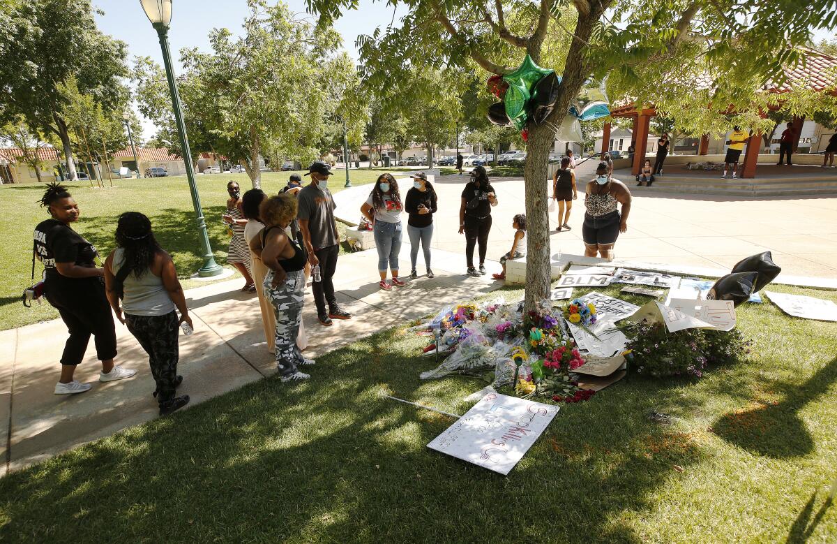 People gather at a memorial for Robert Fuller by Palmdale City Hall, where the young Black man was found hanging from a tree.