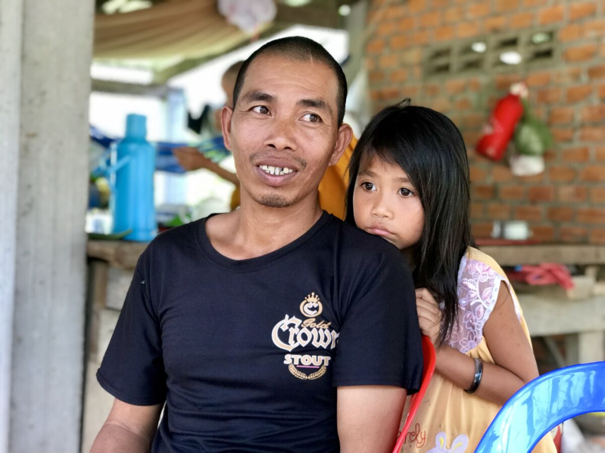 Ros Sitha and his daughter, Siep Vanny, outside their house in Krouch, Cambodia.