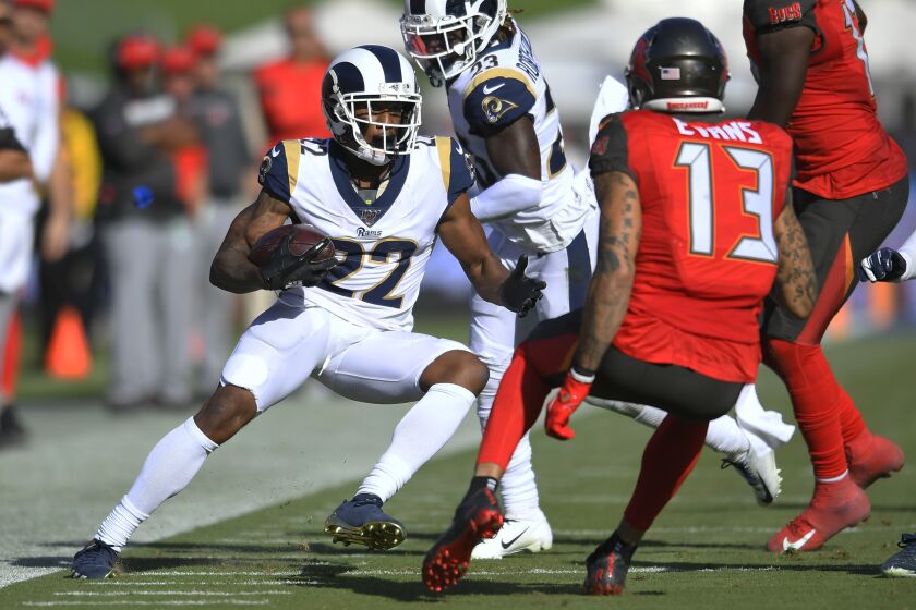 LOS ANGELES, CA - SEPTEMBER 29: Marcus Peters #22 of the Los Angeles Rams avoids Mike Evans #13 of the Tampa Bay Buccaneers after an interception in the fourth quarter at Los Angeles Memorial Coliseum on September 29, 2019 in Los Angeles, California. Tampa Bay won 55-40. (Photo by John McCoy/Getty Images)