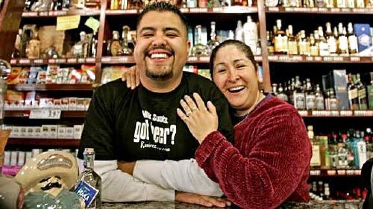 FAMILY BUSINESS: Alex Ramirez and his mother, Teresa Ramirez, at Ramirez Liquor.