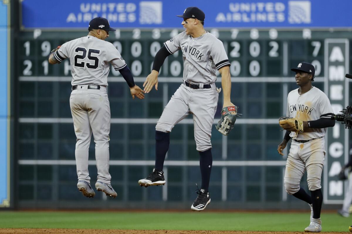 New York Yankees second baseman Gleyber Torres, left, and right fielder Aaron Judge celebrate after their win against the Houston Astros in Game 1 of baseball's American League Championship Series Saturday, Oct. 12, 2019, in Houston. (AP Photo/Matt Slocum)