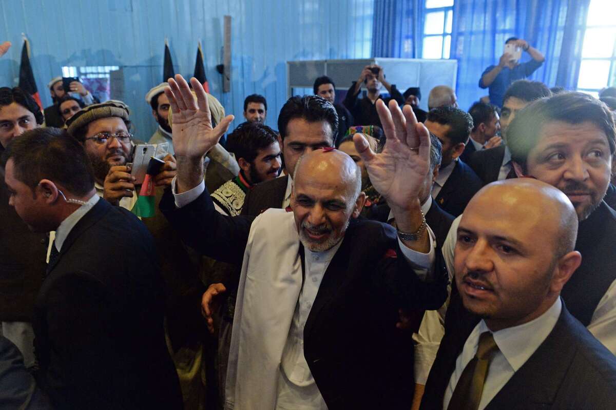 Ashraf Ghani, center, was elected president of Afghanistan in 2014. He replaced Hamid Karzai.