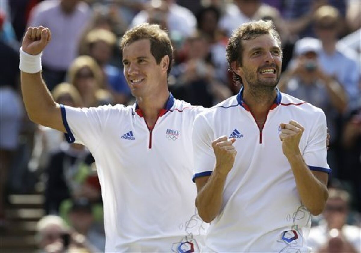Richard Gasquet, left, and Julien Benneteau of France celebrate after beating David Ferrer and Feliciano Lopez of Spain in the men's doubles bronze medal match at the All England Lawn Tennis Club at Wimbledon, in London, at the 2012 Summer Olympics, Saturday, Aug. 4, 2012. (AP Photo/Mark Humphrey)