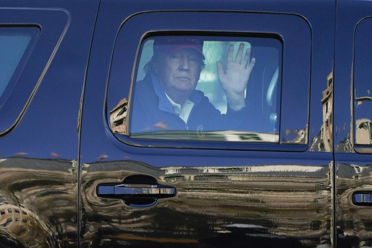President Trump waves to supporters from his motorcade as people gathered for a march in Washington on Saturday.