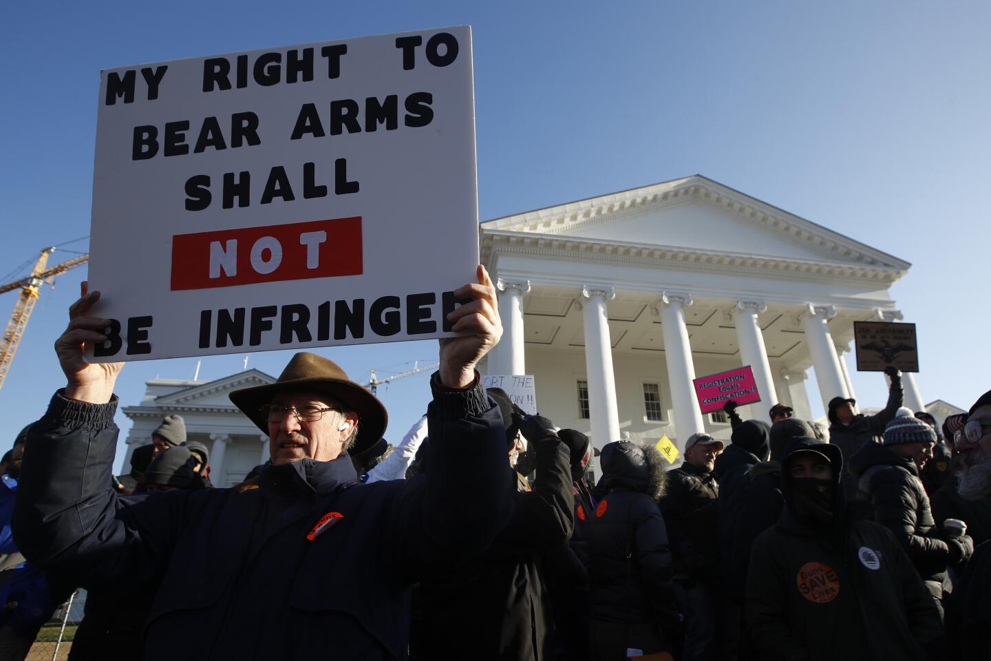 Billy Llewellyn, of Hanover Va., holds a sign in front of the Virginia State Capitol.