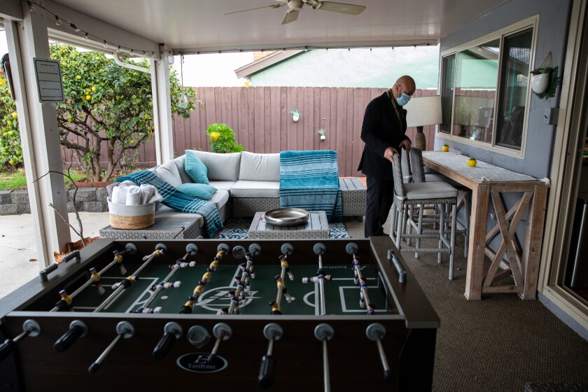 Navid Namdar adjusts furniture in the backyard of his Chula Vista home on Wednesday.