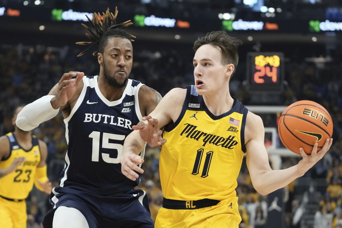 Marquette's Tyler Kolek gets past Butler's Manny Bates during the first half of an NCAA college basketball game Saturday, Feb. 4, 2023, in Milwaukee. (AP Photo/Morry Gash)